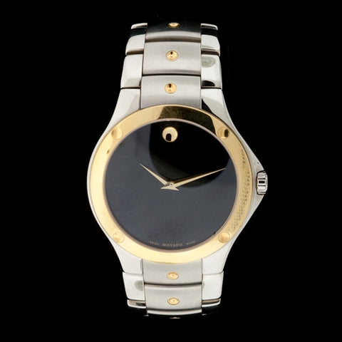 Men's Sport Edition Movado Black Museum Dial with Gold-Tone Bezel, Dauphine Hands  and signature concave dots at 12 o'clock, on the bezel and on each Stainless Steel bracelet link.