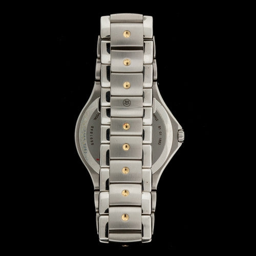 Men's Sport Edition Movado Black Museum Dial with Gold-Tone Bezel, Dauphine Hands  and signature concave dots at 12 o'clock, on the bezel and on each Stainless Steel bracelet link.