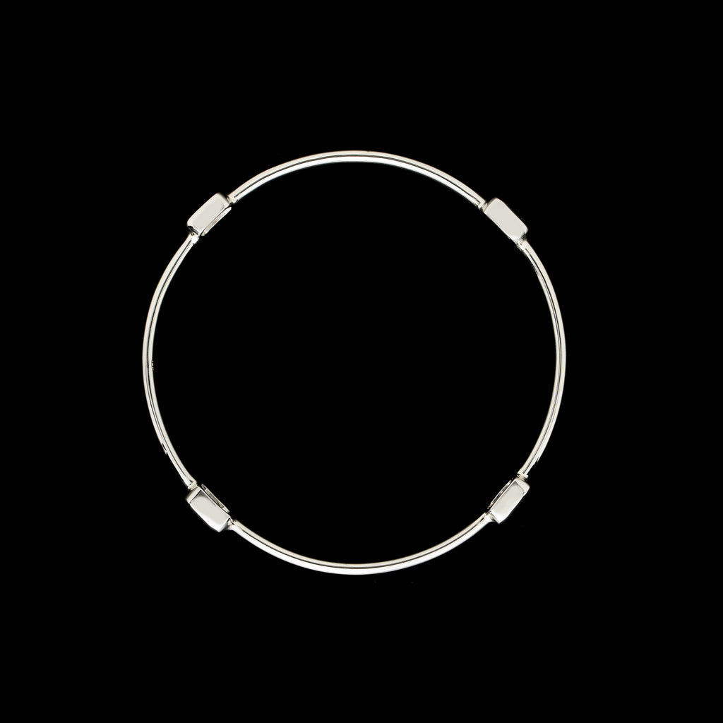 White Gold Bangle Featuring Four Emerald Cut Diamonds